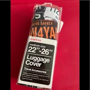 Primeware luggage cover.  Medium size 22”-26”.  Features license plates all over
